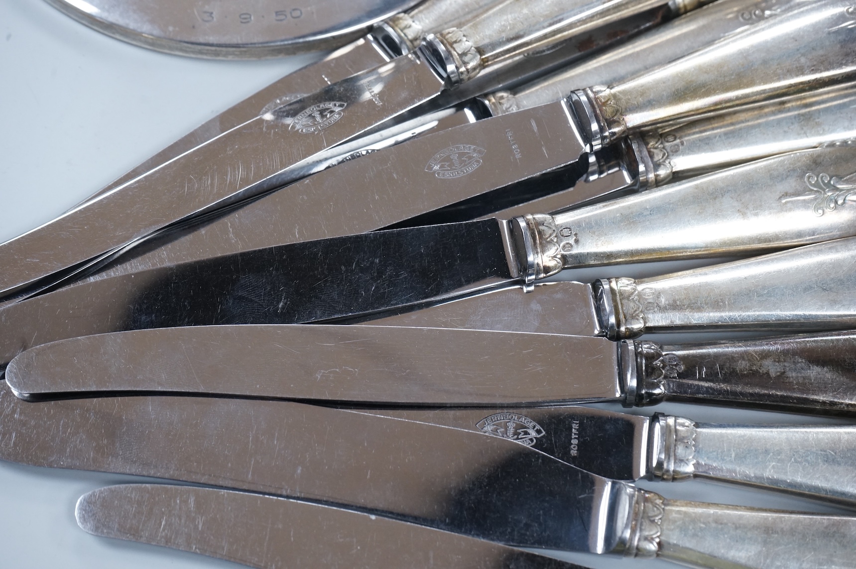 A George V loaded silver capstan-shaped inkwell, mm. W N Ltd, Birmingham 1931, 16.5cm diameter and twelve various Danish loaded silver handled knives with stainless steel blades